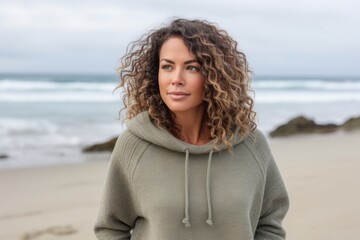 Portrait of a beautiful young woman with curly hair at the beach
