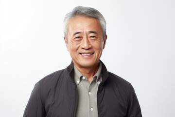 Portrait of a happy asian senior man smiling against white background