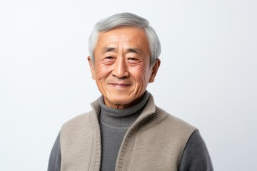 Portrait of happy senior asian man in grey sweater on white background