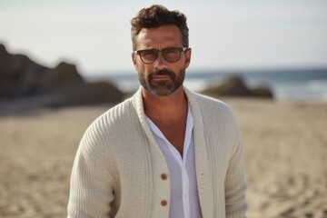 Portrait of handsome man wearing eyeglasses standing on the beach