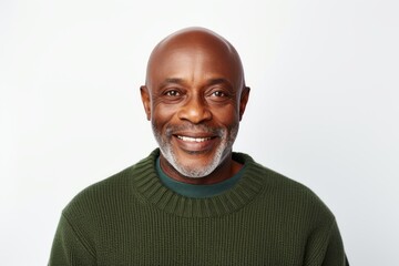 Portrait of a smiling senior man in a green sweater against white background