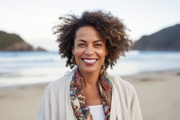 Portrait of smiling woman with afro hairstyle at the beach