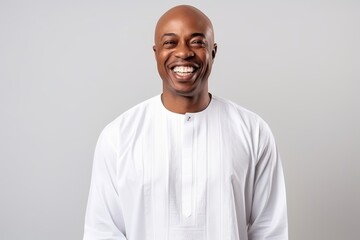 Fototapeta premium happy african american man smiling and looking at camera isolated on grey