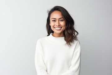 Fototapeta premium Portrait of a smiling young woman looking at camera isolated on a white background