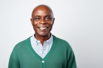 Fototapeta premium Portrait of a happy mature african man smiling against white background