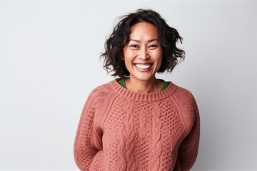 Portrait of a smiling woman in sweater looking at camera isolated on a white background