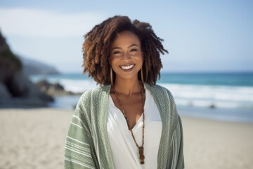 Portrait of smiling woman standing on the beach on a sunny day