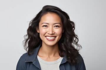 Portrait of a smiling young asian woman looking at camera.