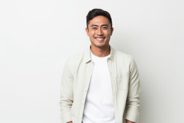 Fototapeta premium Portrait of a happy young asian man smiling at the camera