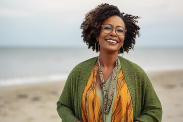 Portrait of a smiling african american woman wearing glasses on the beach