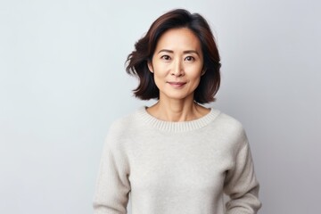 Portrait of a middle-aged asian woman on white background