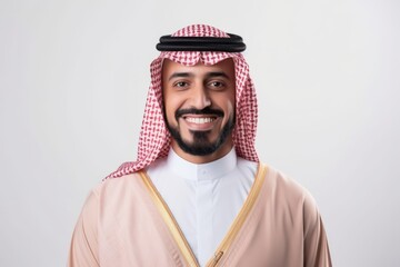 Portrait of a smiling arabic man standing over white background