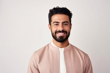 Obraz premium Portrait of a handsome young man smiling at camera over white background
