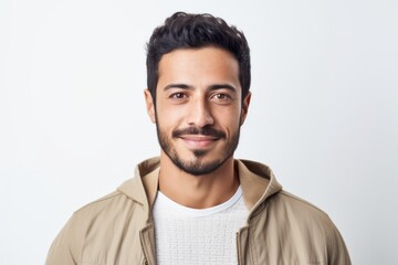 Fototapeta premium Portrait of a handsome young man smiling at camera over white background