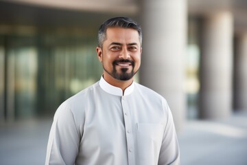 Naklejka premium Portrait of a smiling mature man standing in the hallway of a modern building