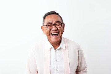 Obraz premium Portrait of happy senior asian man laughing on white background.