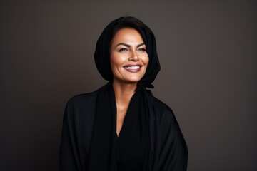 Fototapeta premium Portrait of a beautiful woman in a turban and black dress