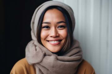 Portrait of a beautiful young asian woman wearing scarf and warm clothes