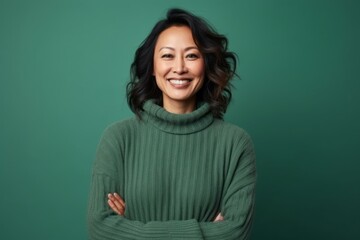 Medium shot portrait photography of a pleased Indonesian woman in her 40s wearing a cozy sweater against an abstract background 