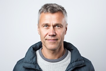 Portrait of a handsome middle-aged man looking at camera against white background