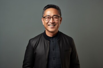 Obraz premium Portrait of a happy asian man in black leather jacket and glasses