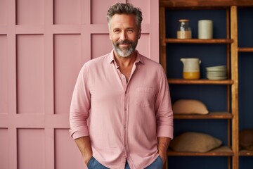 Naklejka premium Portrait of a handsome middle-aged man in a pink shirt