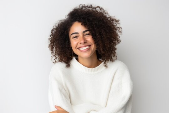 Lifestyle portrait photography of a pleased Brazilian woman in her 30s wearing a cozy sweater against a white background 