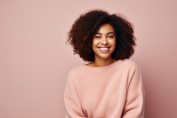 Fototapeta premium Beautiful african american woman with afro hairstyle smiling at camera