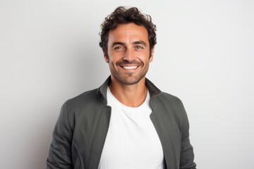 Portrait of handsome young man smiling and looking at camera against white background