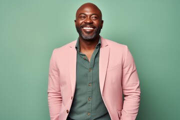 Obraz premium Portrait of a happy african american man in pink jacket