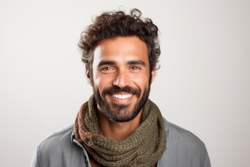 Obraz premium Portrait of a handsome young man wearing scarf and smiling at camera.