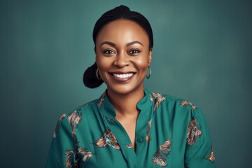 Portrait of smiling african american woman in turquoise dress