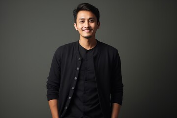 Obraz premium Portrait of a happy young asian man isolated on grey background