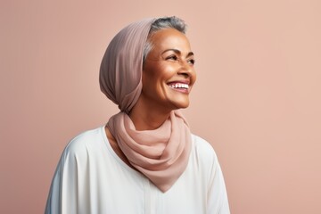 Portrait of a smiling middle-aged muslim woman wearing hijab