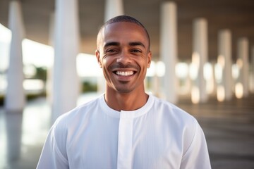 Fototapeta premium Portrait of young african american man smiling at camera in mosque