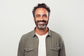 portrait of handsome middle aged man smiling at camera isolated on grey