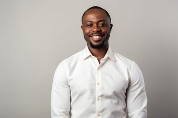 smiling african american man in white shirt isolated on grey