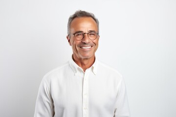 Portrait of smiling mature man in eyeglasses against white background
