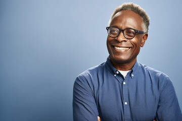 Portrait of smiling african-american man in glasses, isolated on blue background