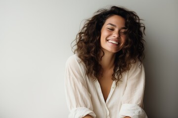 Portrait of a smiling young woman with curly hair in bathrobe