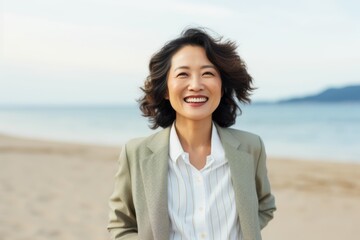 portrait of happy asian businesswoman on the beach in summer