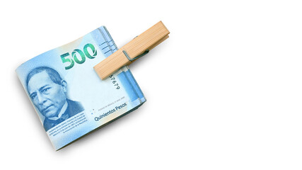 Top-down view of an isolated bundle of bills tied with a paperclip on a white background. Mexican pesos. super peso