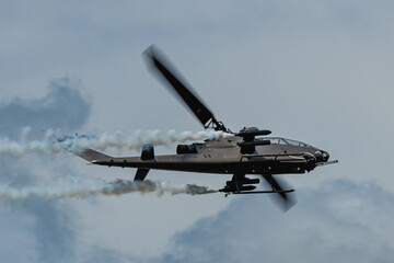 Cobra helicopter high speed pass with smoke from left to right