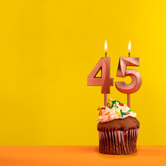 Number 45 birthday candle - Celebration on yellow background