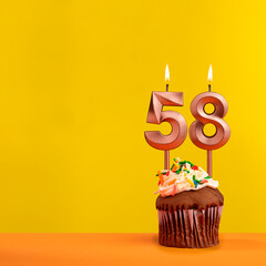 Candle with flame number 58 - Birthday card on yellow background