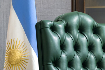 Rio Gallegos, Argentine - March 15, 2023 : a stylish upholstered chair and an argentinian flag in...