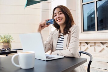 businesswoman holding a credit card.