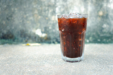 Americano iced coffee or black coffee on cement wall.