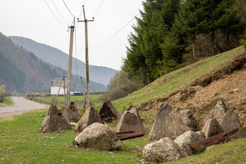 row of anti-tank obstacles, also known as Czech hedgehogs, positioned along a grassy field. Defenses are  from the World War II era © Iri.Andrie