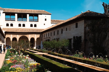 Granada,Spain. April 17, 2022: Architecture and facade of the Generalife Palace with beautiful blue sky.